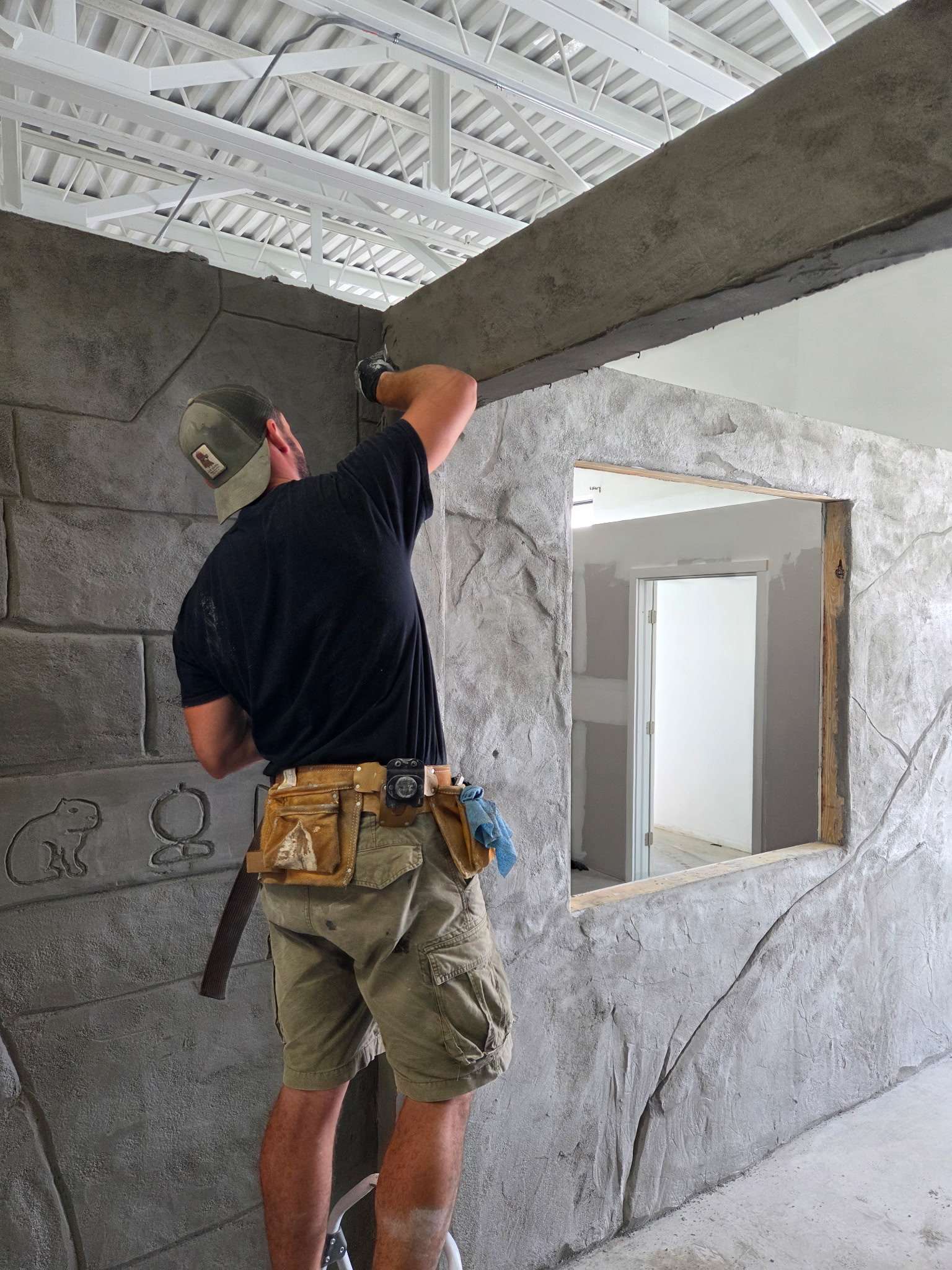 Textured wall panel mid-process, showing the sculpted surface before final color and detail