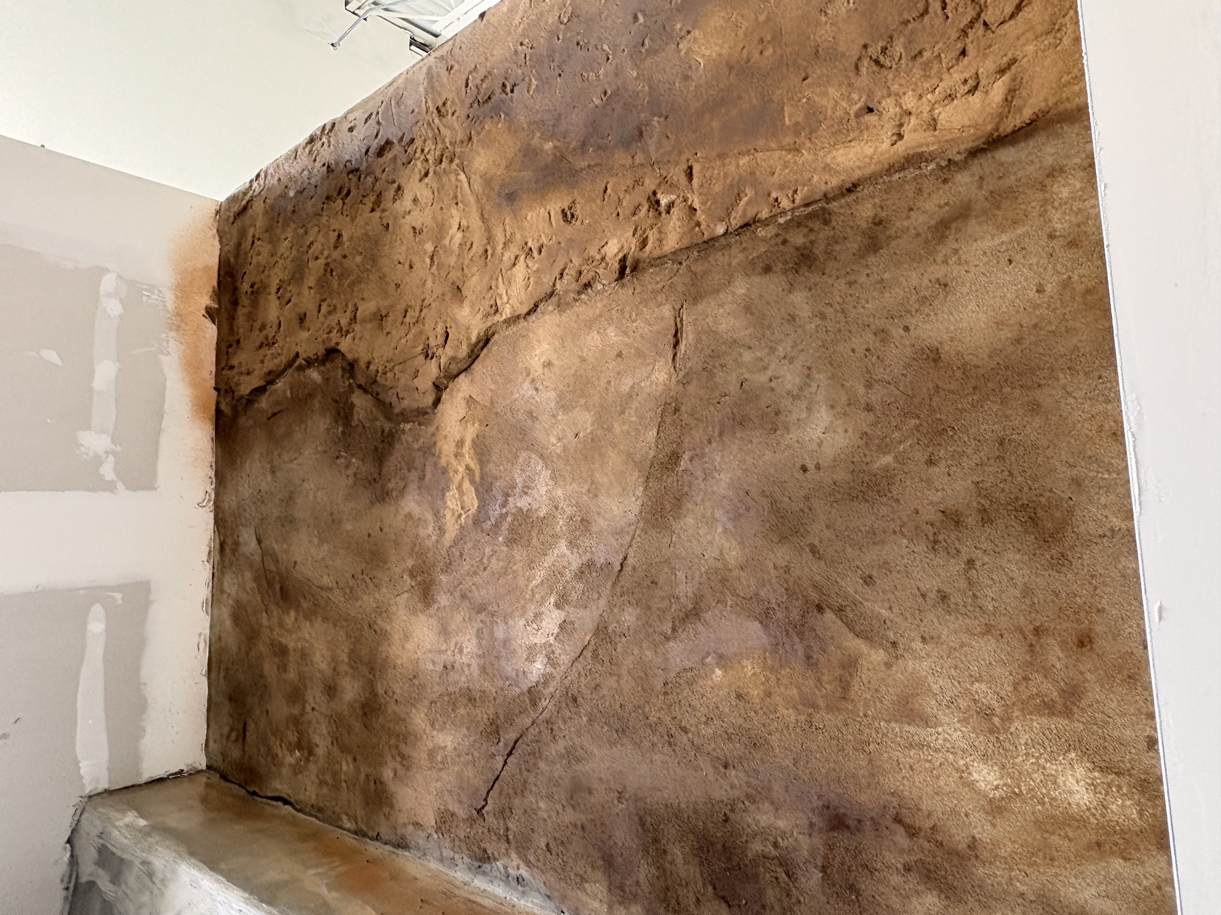 Textured wall panel showing the sculpted base coat in progress