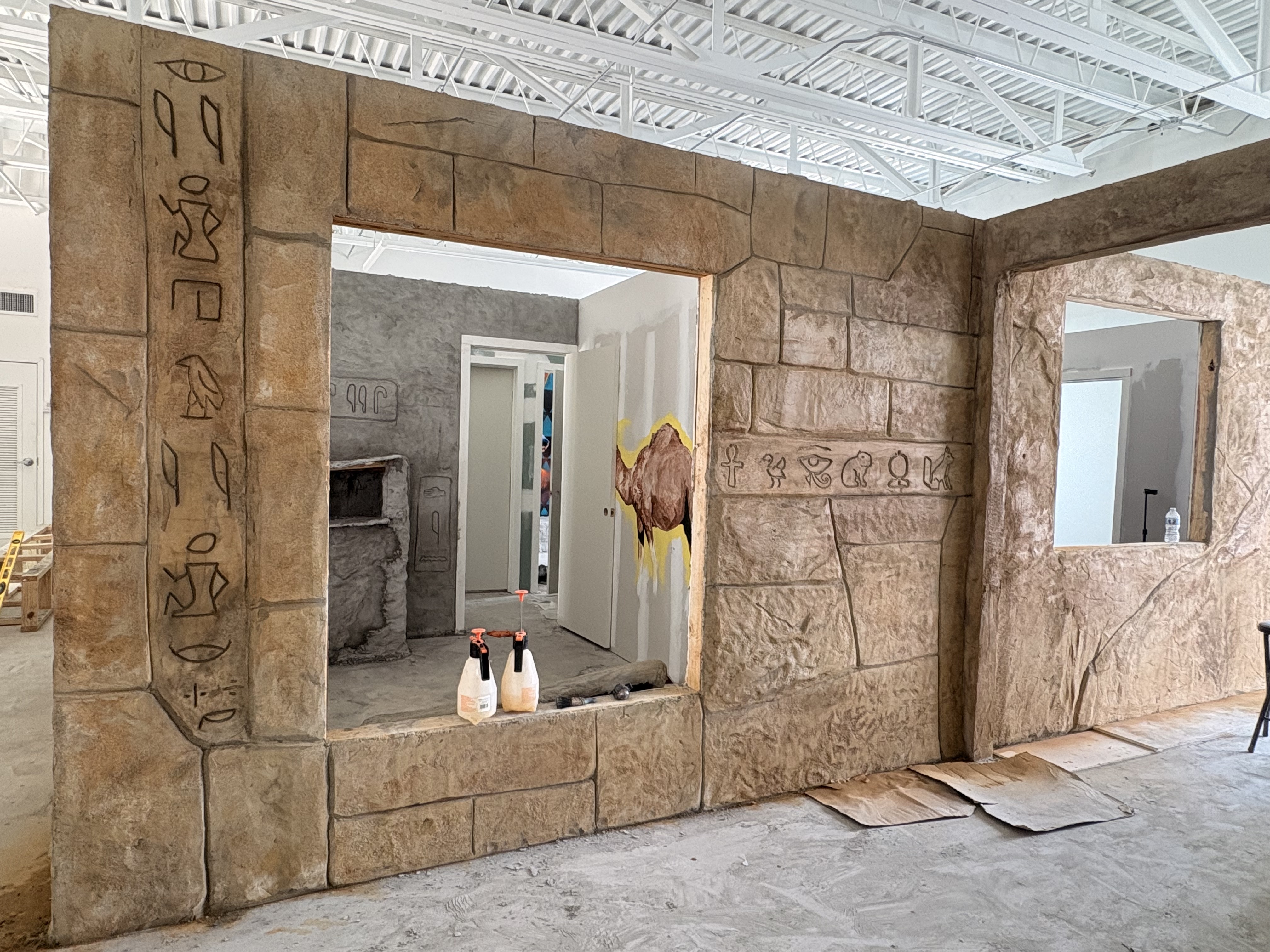 Themed archway with hand-carved hieroglyphic style details on the stone pillars