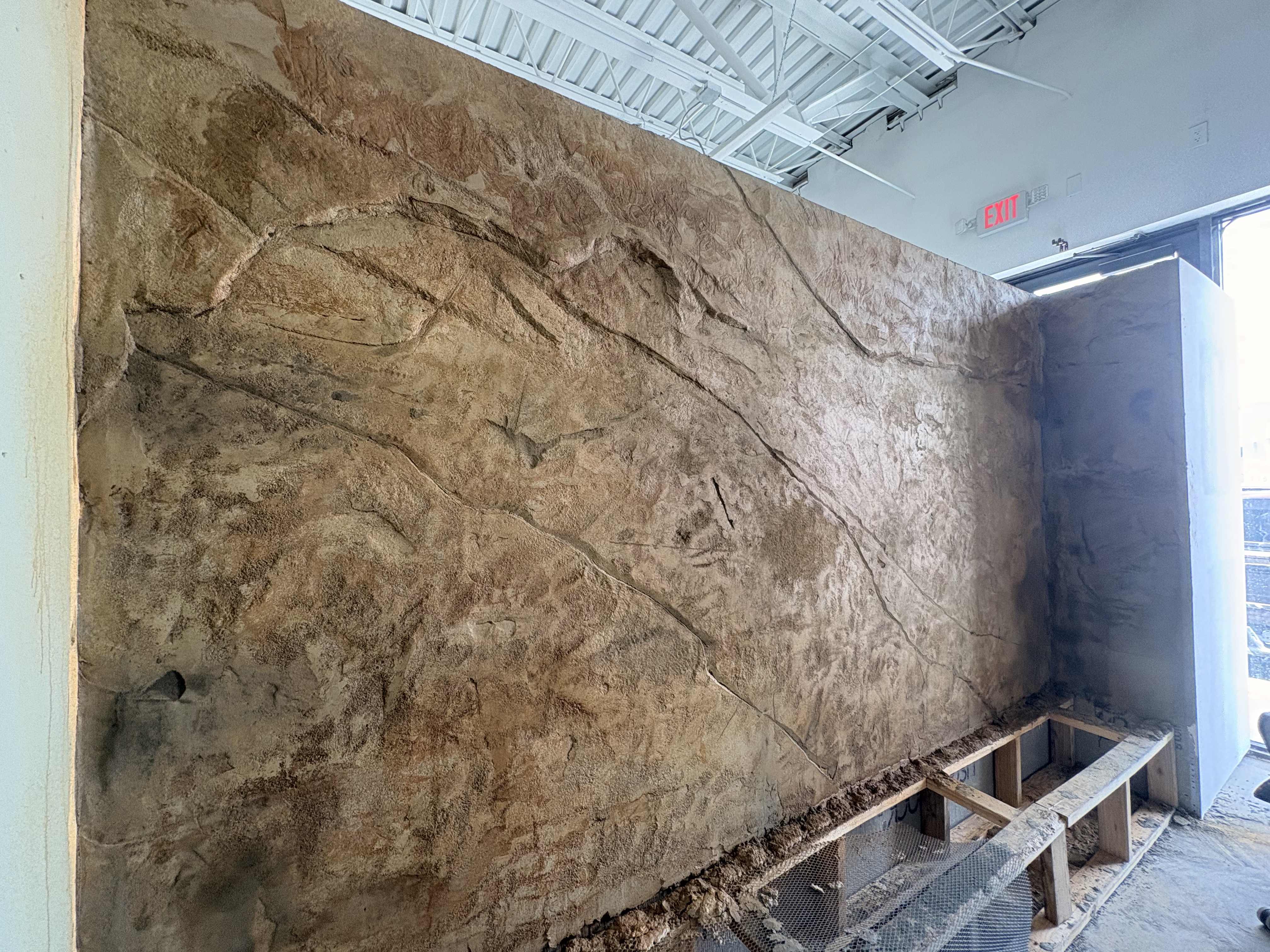 Large rough natural rock textured wall in progress